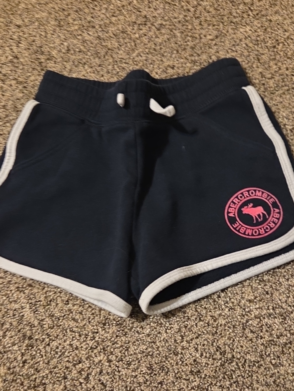 abercrombie kids navy shorts with pink logo and white trim